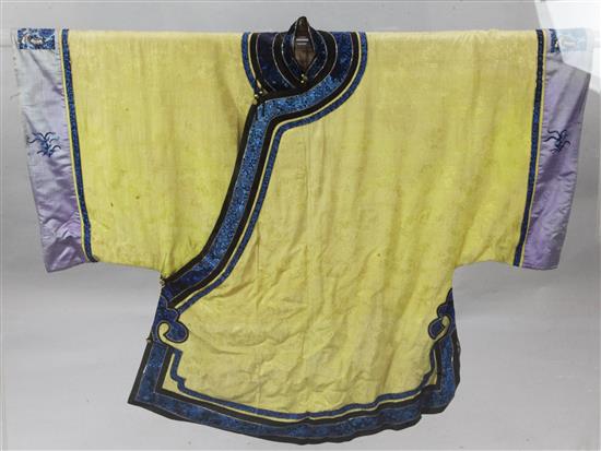 A Chinese yellow silk damask robe, early 20th century, length 97cm, removable perspex case